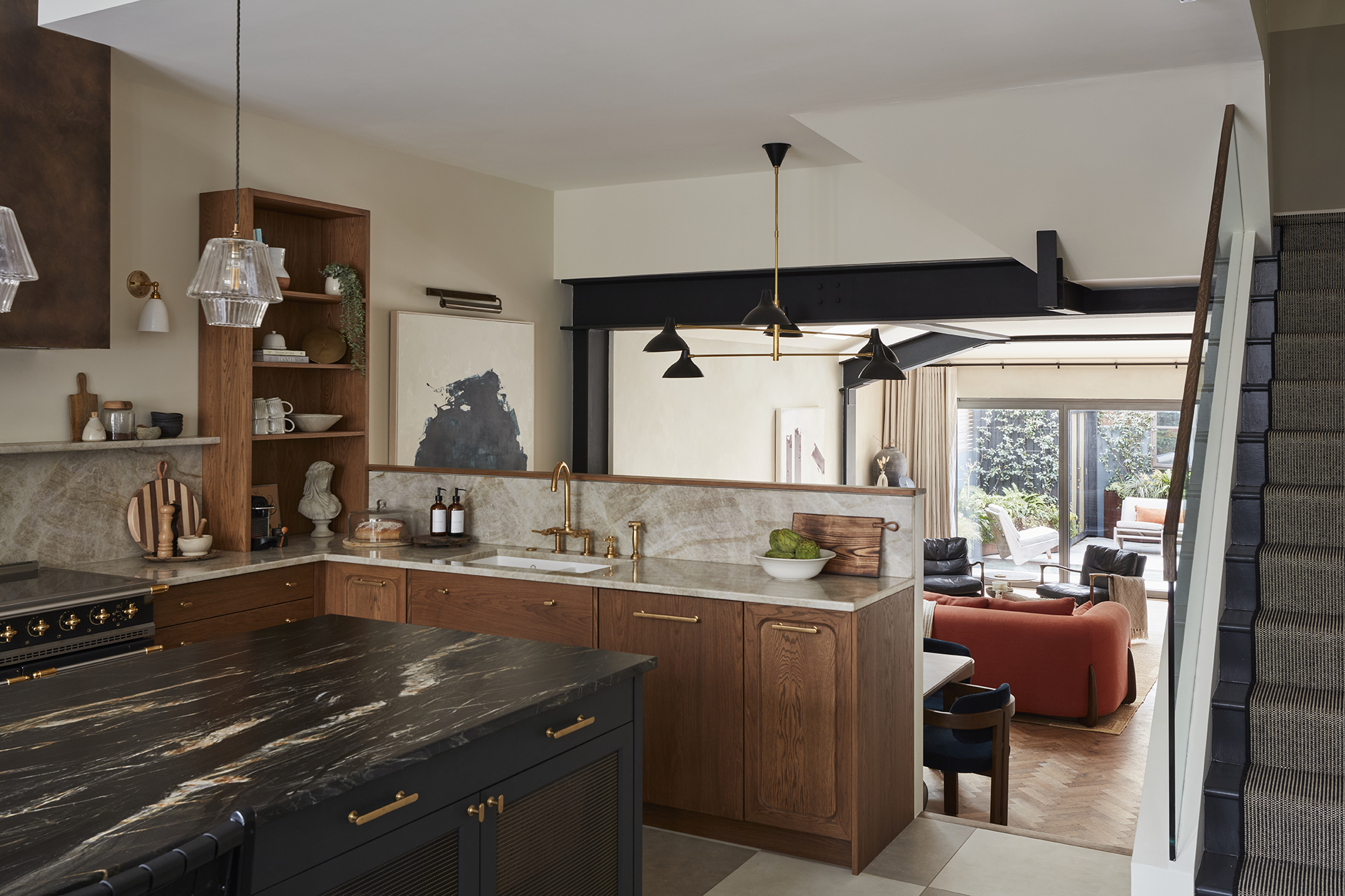 open plan kitchen with black marble countertops and wood cabinets