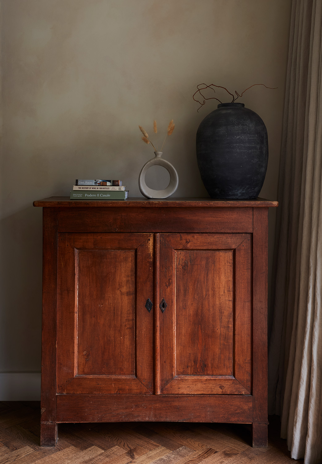 vintage rustic cabinet against textured beige wall