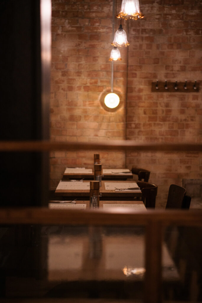 exposed brick cosy lighting over long table