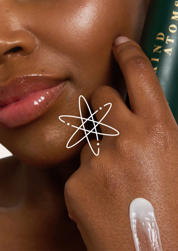 image of skincare model with a dab of moisturizer overlaid with the logo mark